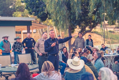 Residents with livestock gather to organize evacuation plans for their animals