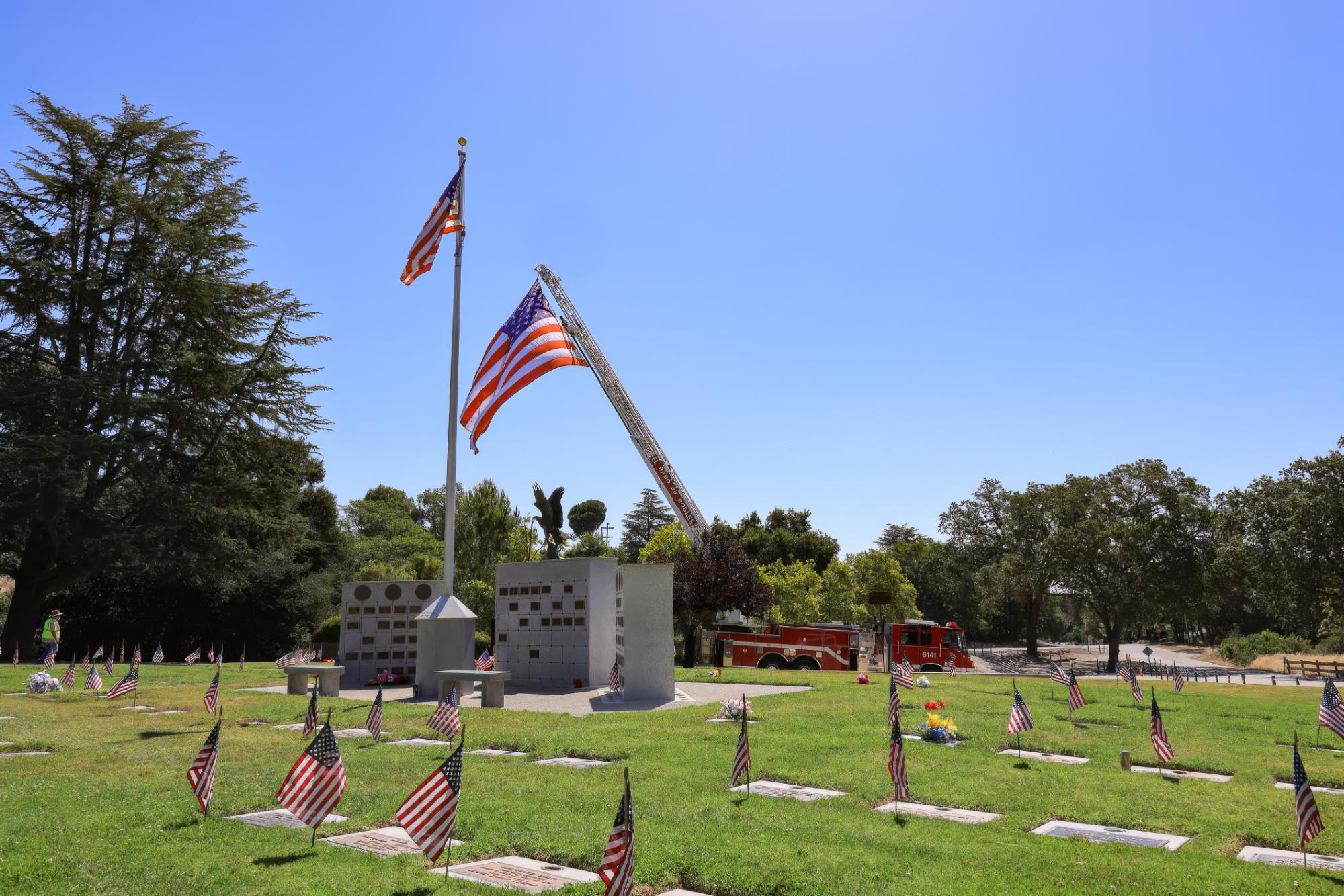 The Paso Robles Fire Department's ladder truck came to display a large American flag at Paso Robles District Cemetery for the May 25 Memorial Day ceremony. Photo by Derek Luff/PRP