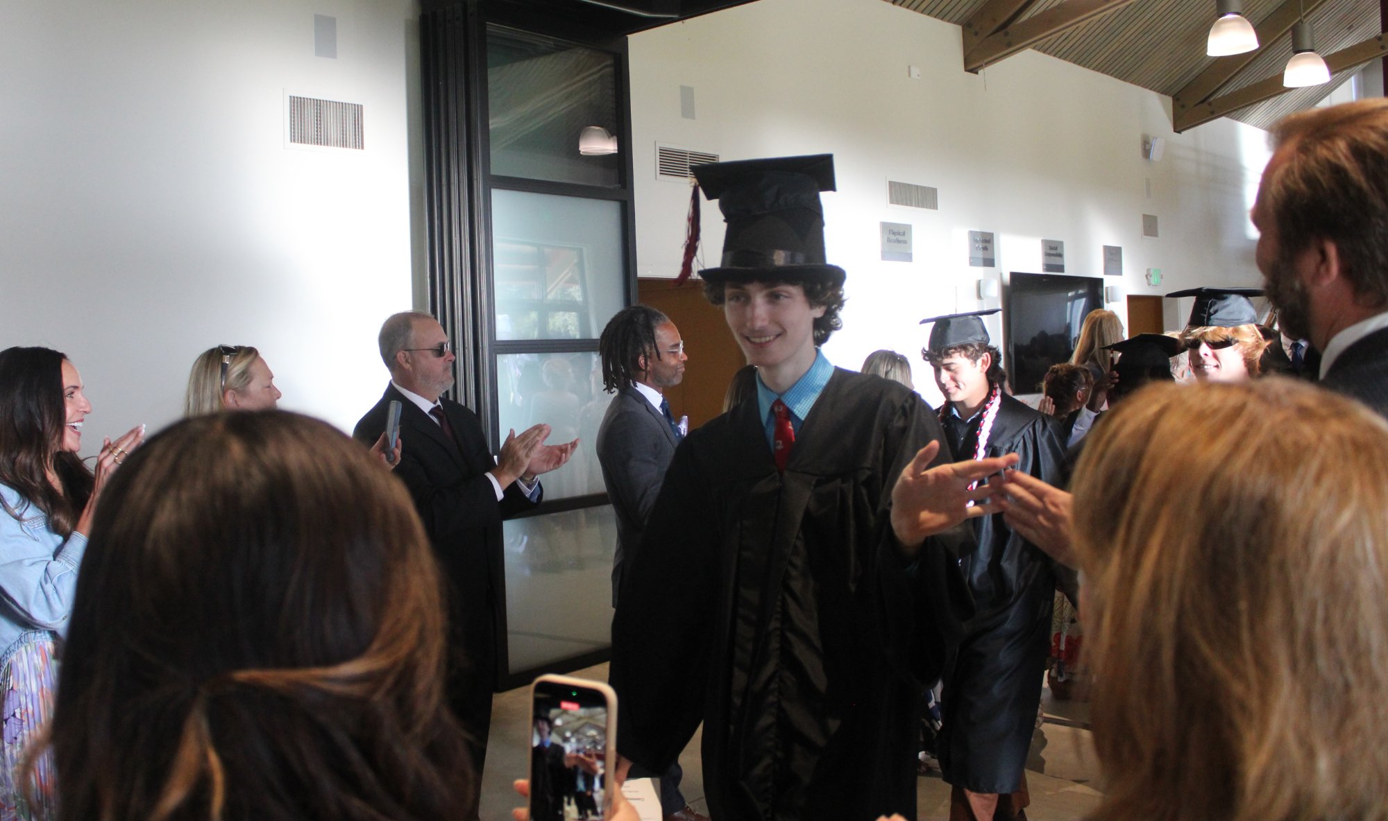 Erickson Denman and his fellow Dunn School Class of 2026 members are greeted by two lines of faculty members before the school's graduation ceremony on May 30. Photo by Mike Chaldu/SYVS