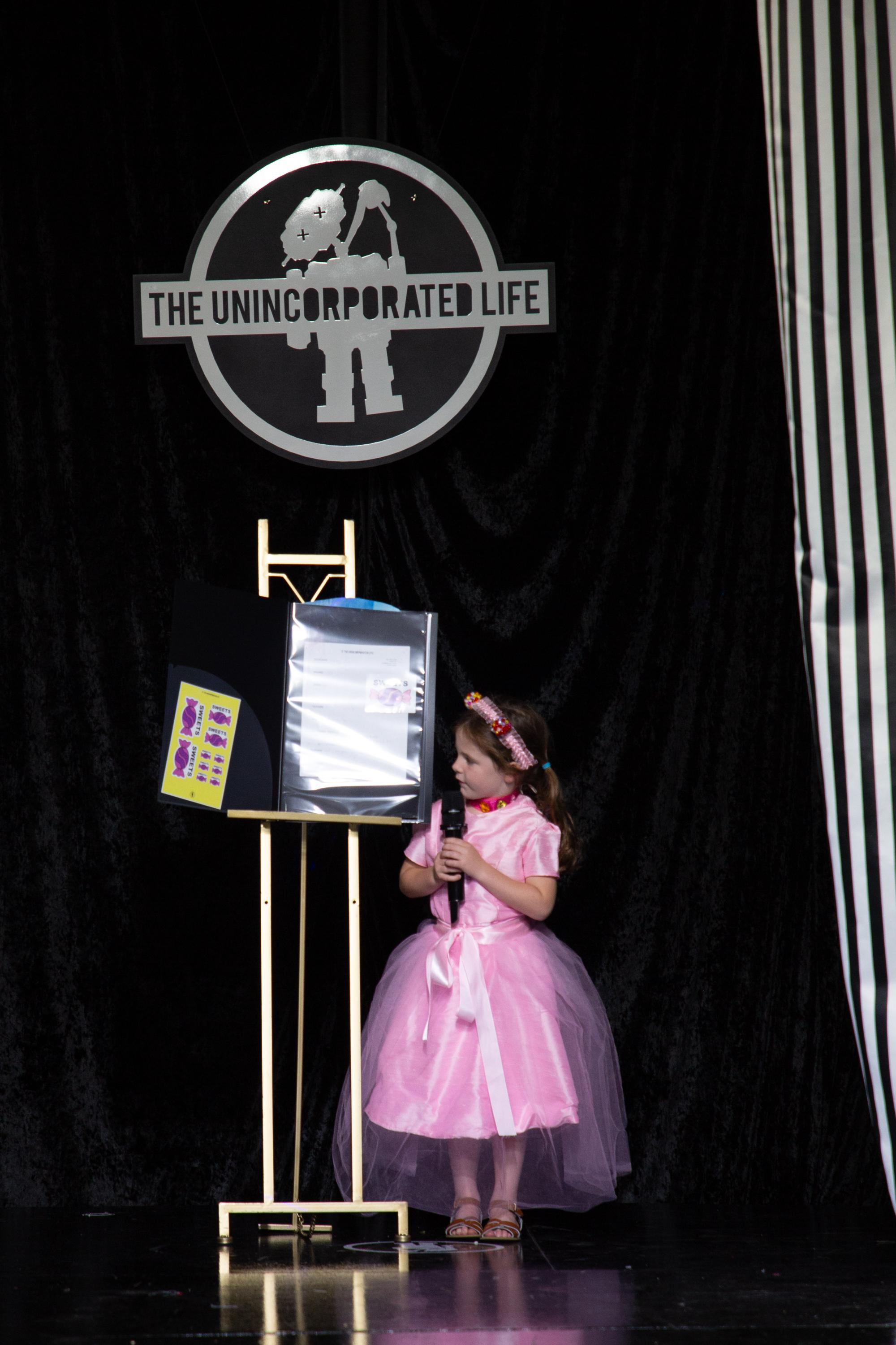 Five-year-old Jordan Johnson proudly showcased her original Summer 2027 design on the runway after spending the week creating her fashion brand, "Sweets." From designing a logo and sewing her garment to confidently presenting her collection, Jordan embraced every step of the creative process, reminding everyone that with Sweets, "we always feel sweet." Photos courtesy of the Johnson Family