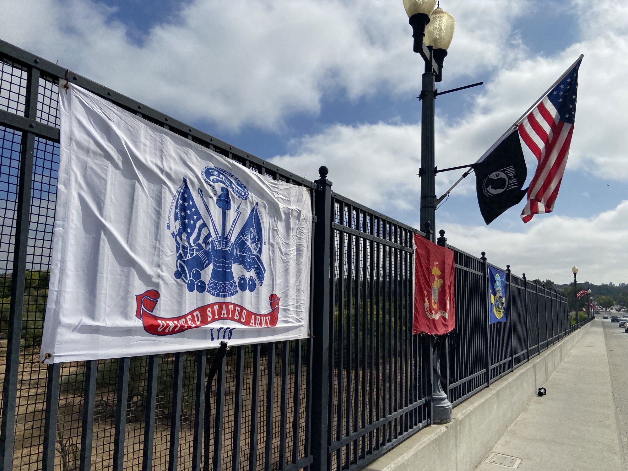 Local Residents Display Flags Along Niblick Bridge to Honor Fallen Soldiers