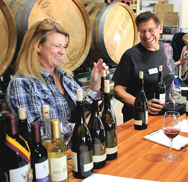Vicky and Pedro Vargas, owners and operators of Vino Vargas, enjoy their jobs ... but never too much.