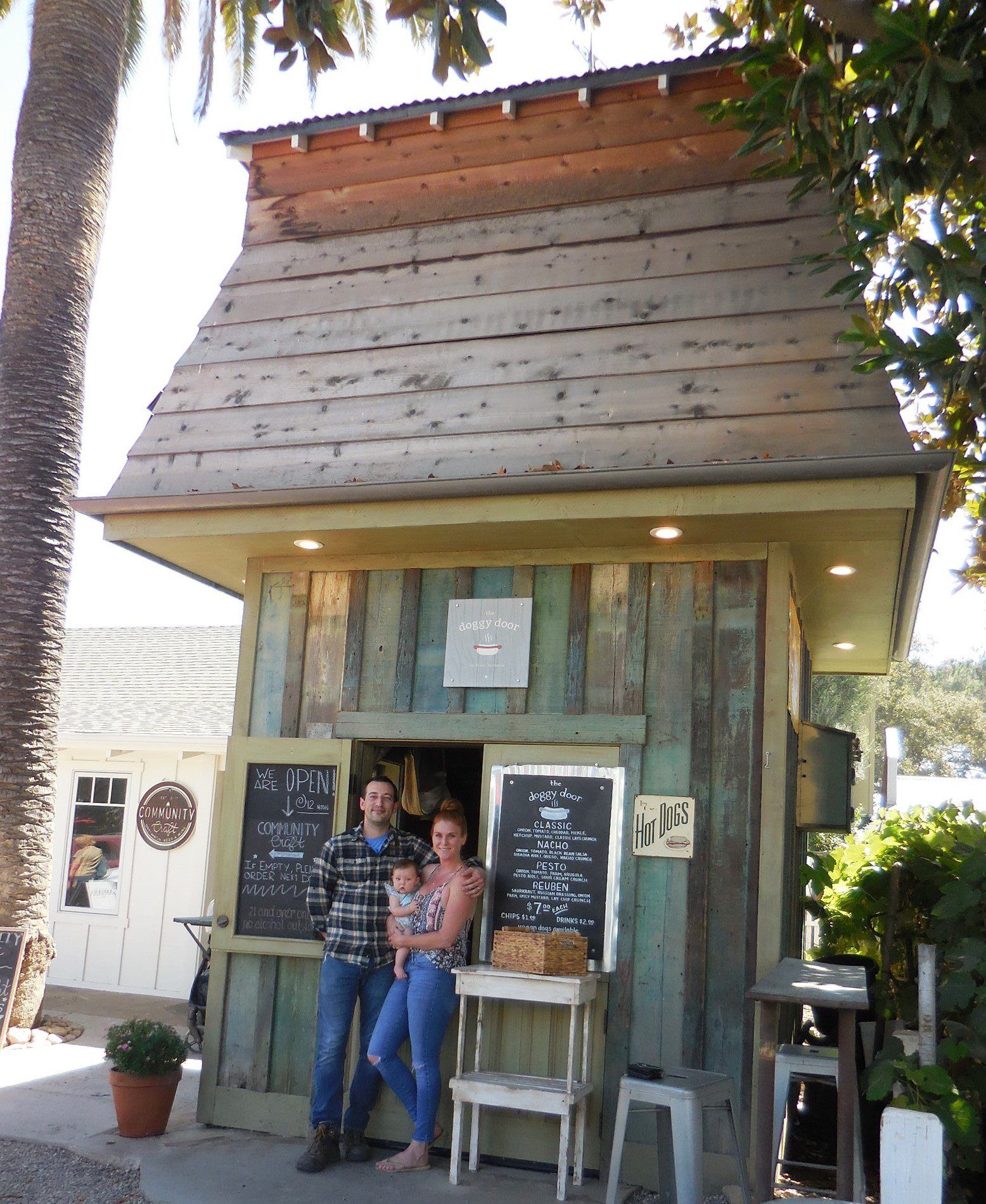 Local couple serving hot dogs with craft beer, wine